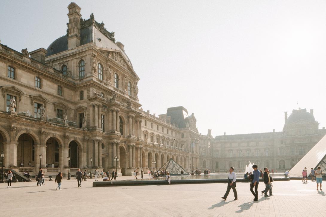 People walking near white building